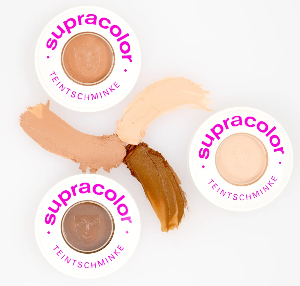Tres envases Supracolor con pinceladas cremosas